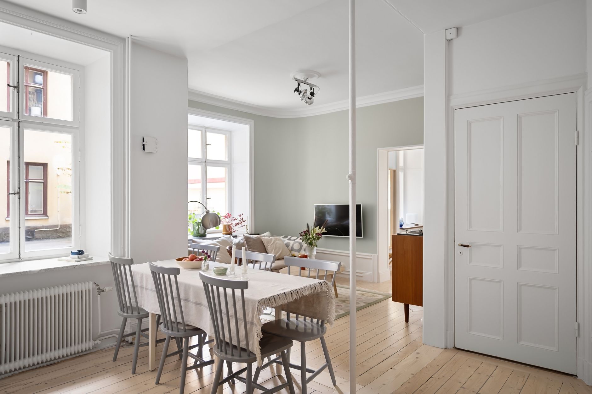 A spacious, light-filled living and dining area with minimalist decor
